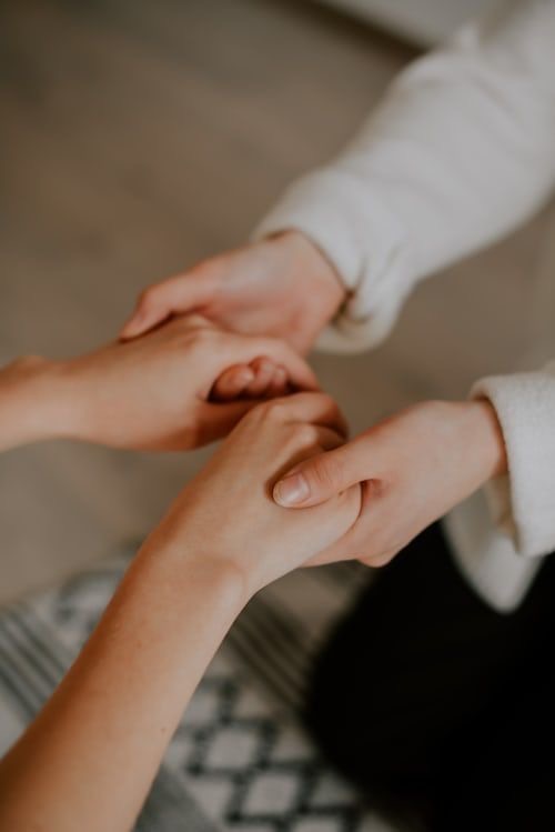 Hands holding each other tightly